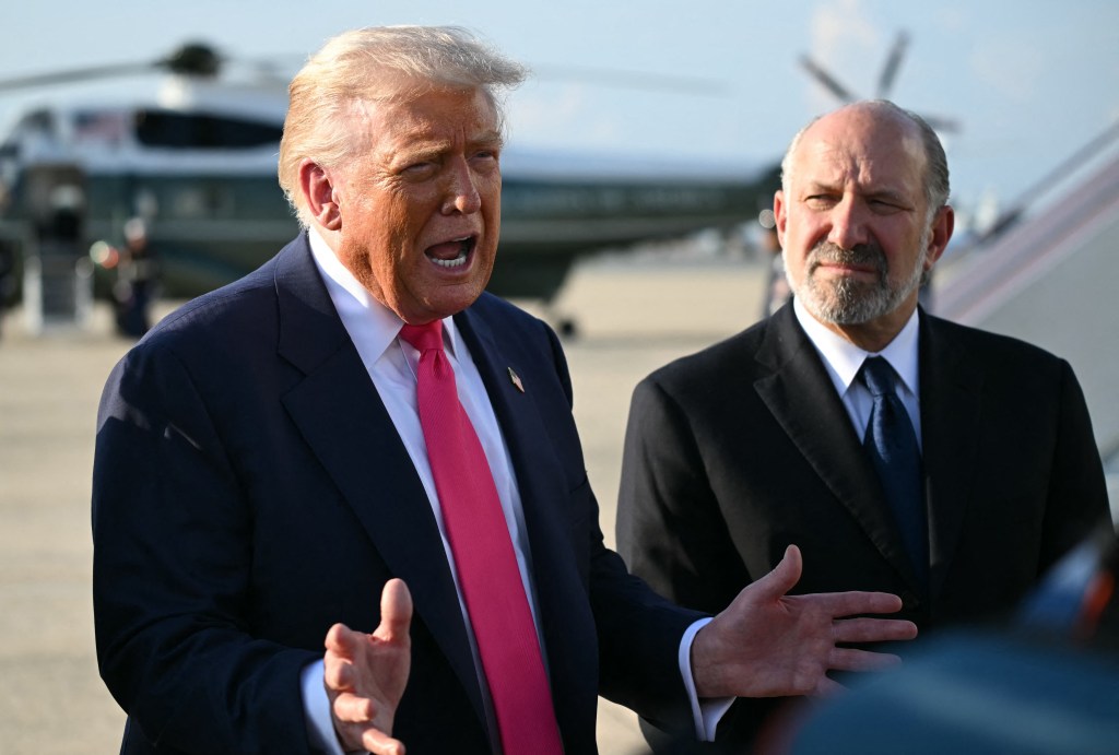 President Donald Trump speaking to reporters, with another man beside him.