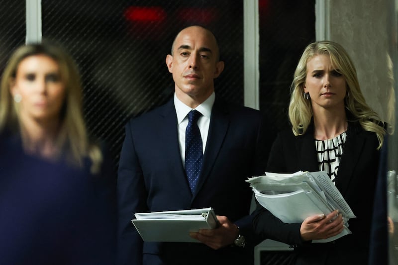Natalie Harp (right) is known as the "human printer" who followed Trump around with a portable printer and battery pack.