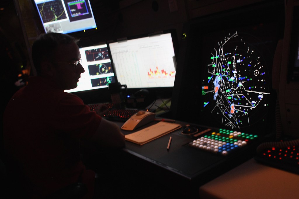 Air traffic controller monitoring flights at Denver International Airport.
