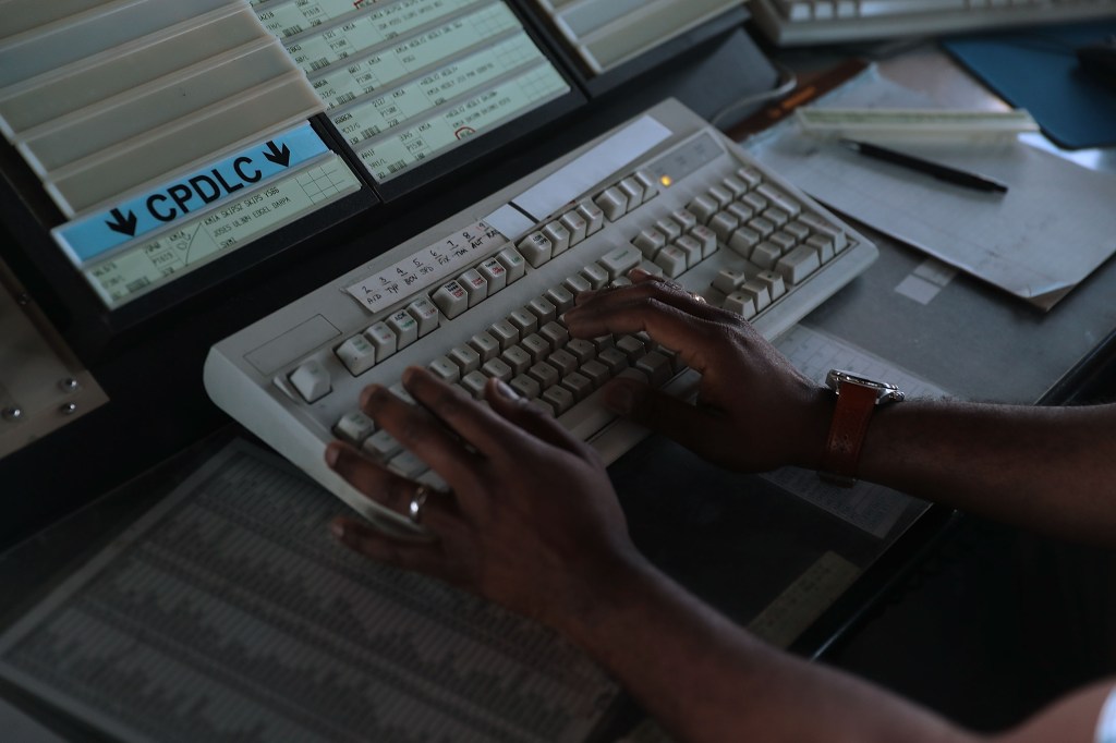 Air traffic controller using Data Comm system.