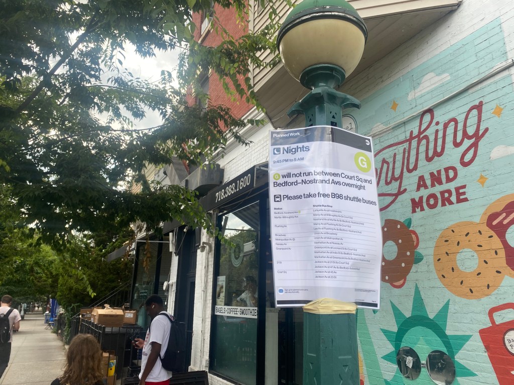 Image of a sign outside a G train station describing the suspended service. 