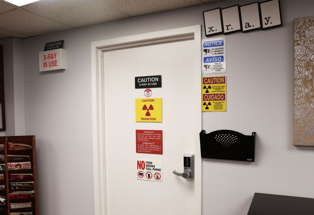 X-ray room door with warning signs.
