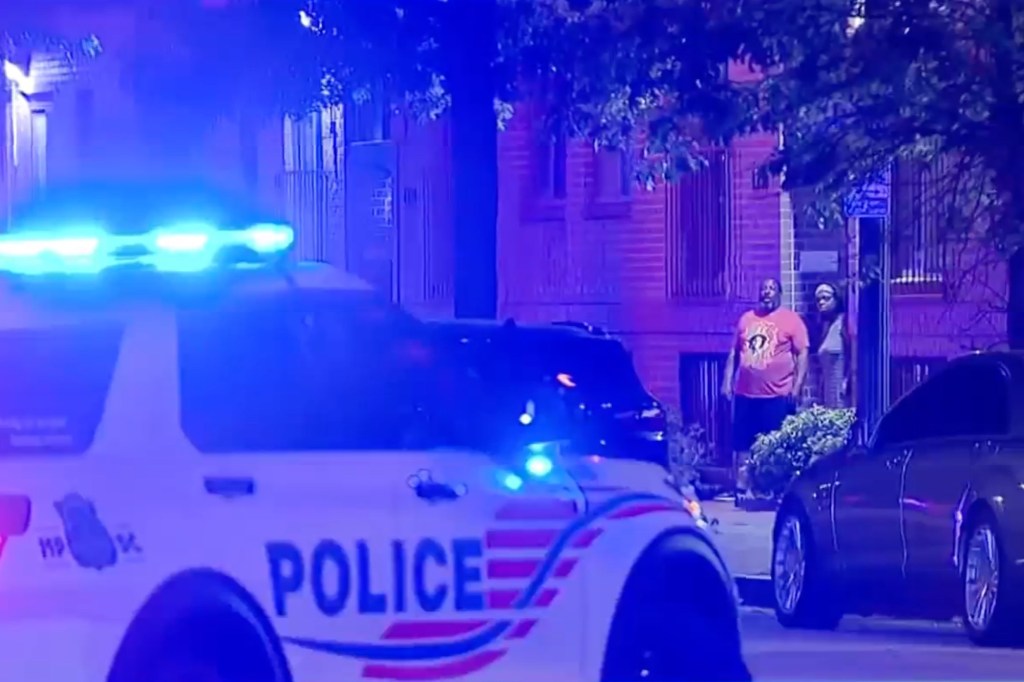 Police car at night scene of triple shooting.