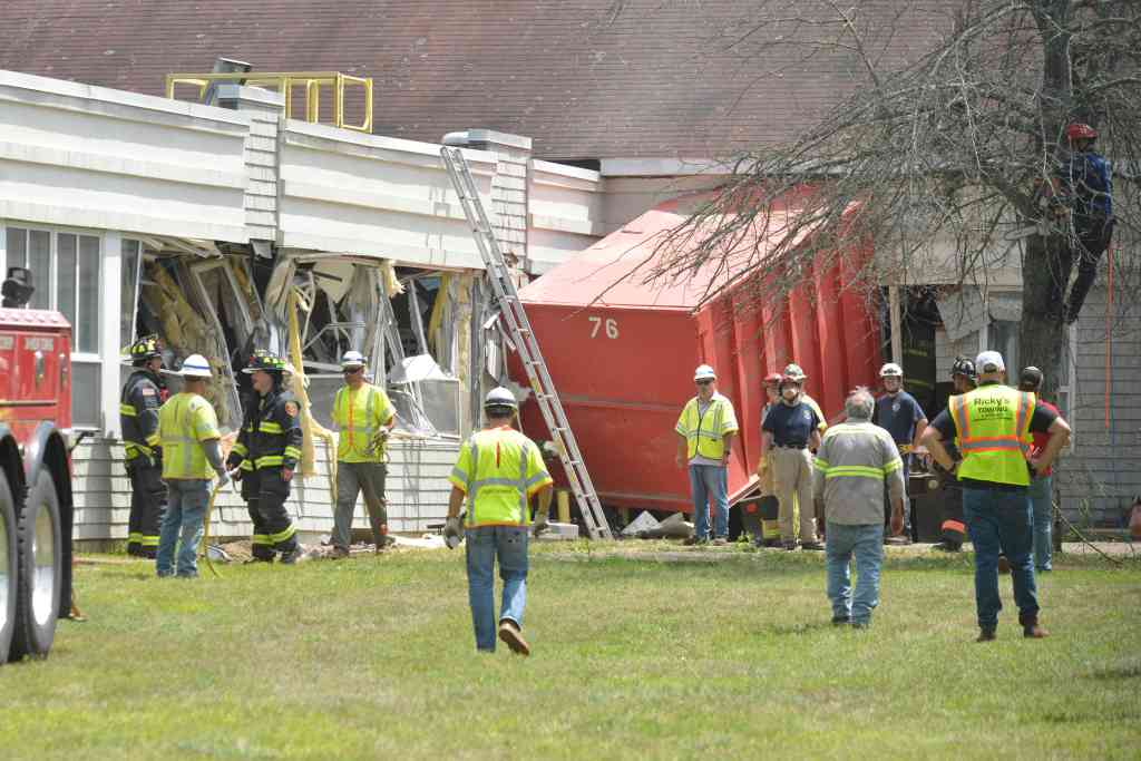 Truck crashed into a building.  Emergency responders at the scene.