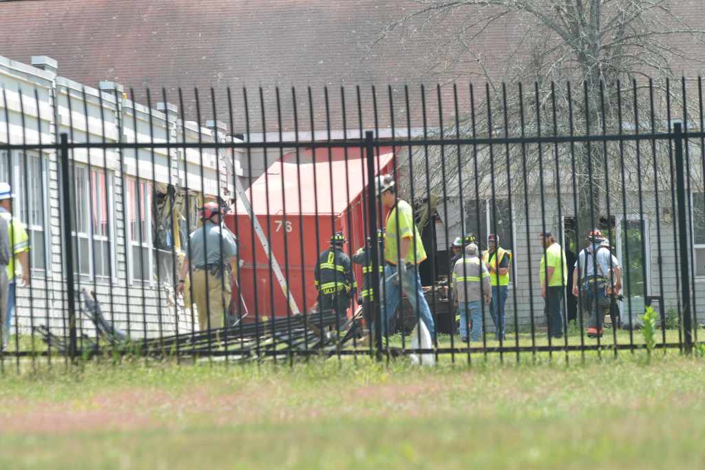 Truck crashed into a building.  Emergency responders at the scene.