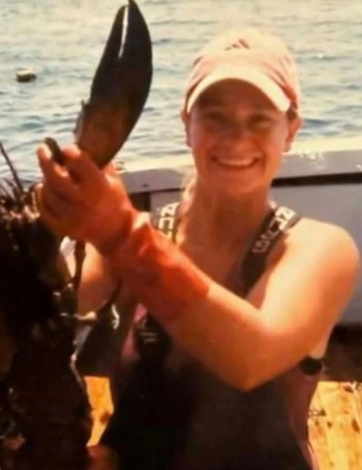 Woman holding a lobster claw.