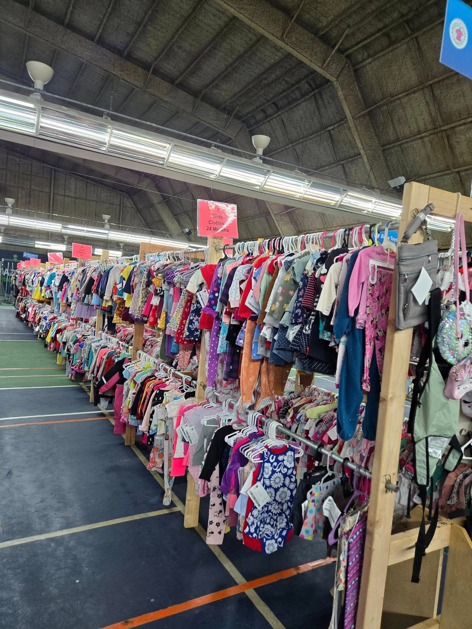 kids clothes on racks in a giant warehouse