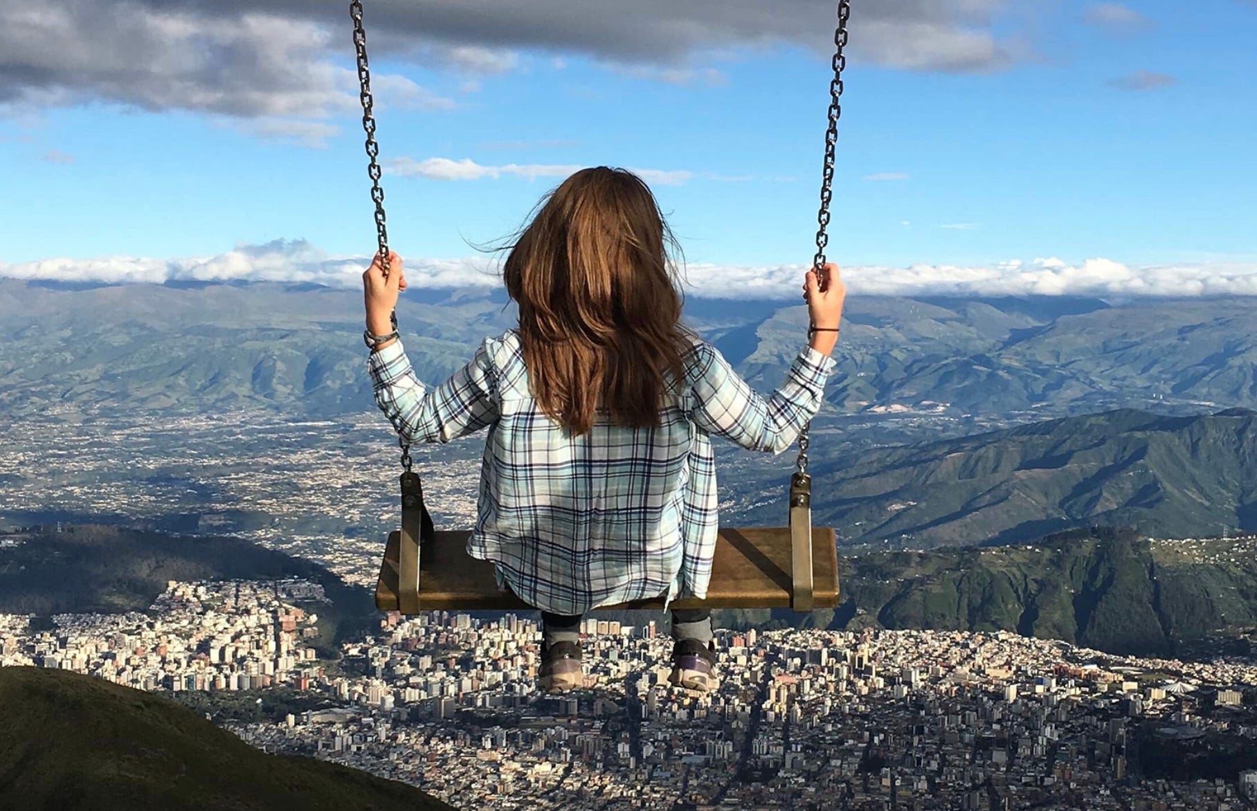 The writer in Quito, Ecuador on a swing.