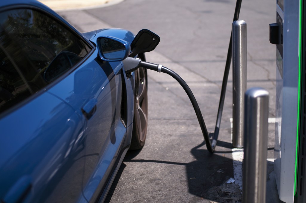 Electric vehicle charging at a station.