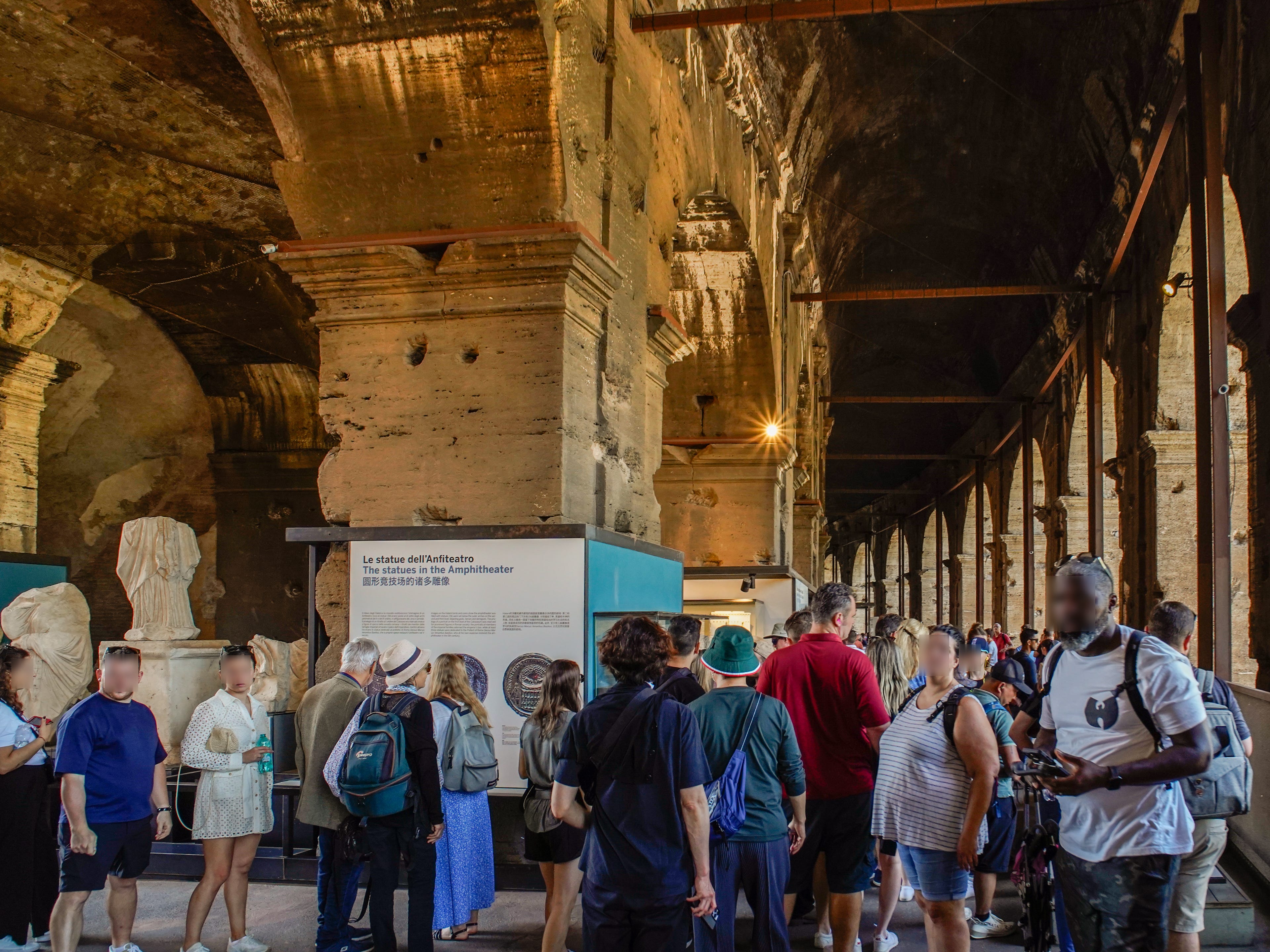 Crowds of people look at exhibits inside the Colosseum in Rome