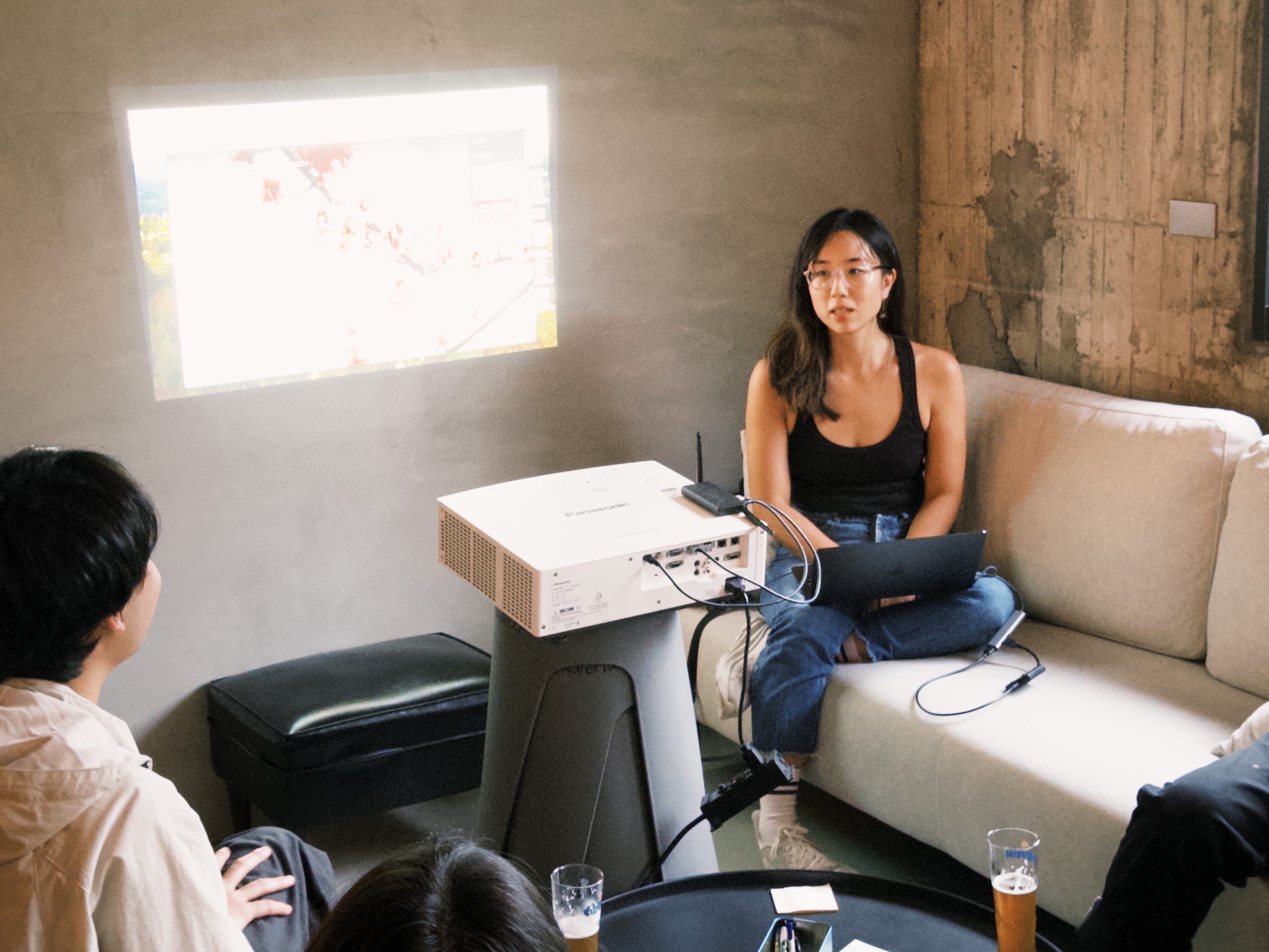 Ginny Wu is sitting near a projector.