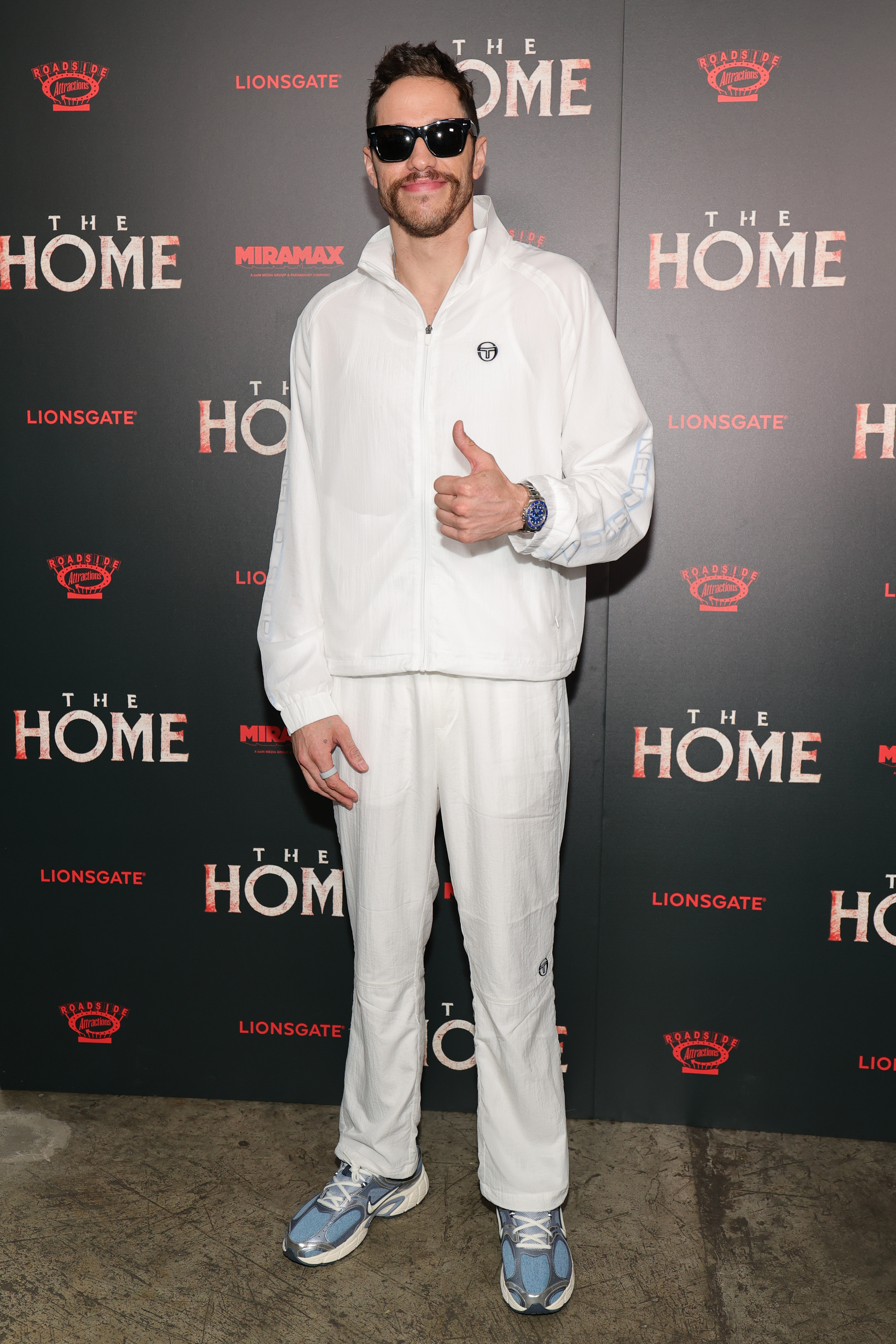 Pete Davidson wearing white at an event. 