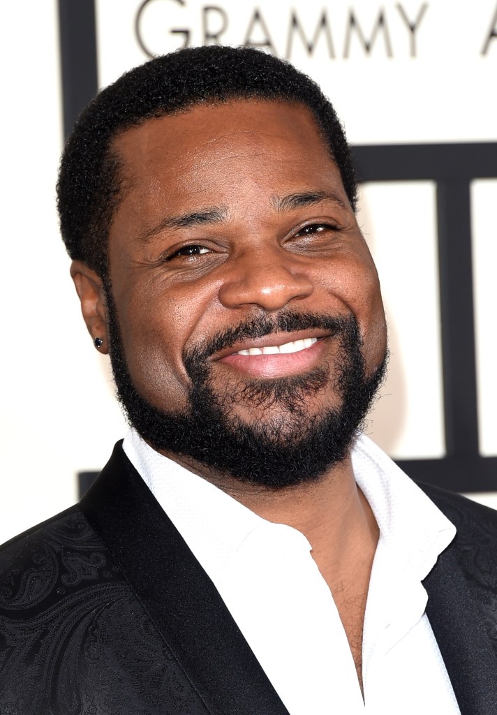 Malcolm-Jamal Warner smiling on the red carpet.