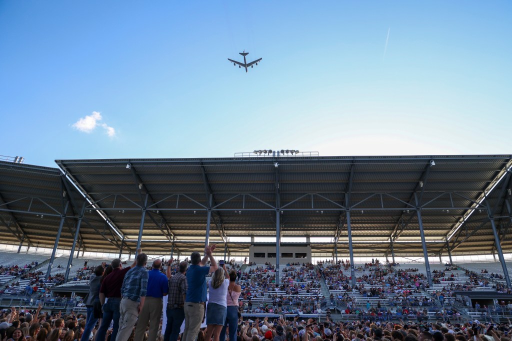 B-52 bomber flyover at a stadium.