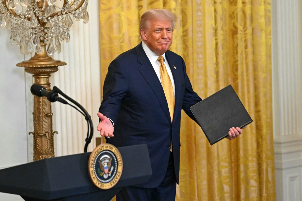 Donald Trump at a podium in the White House.