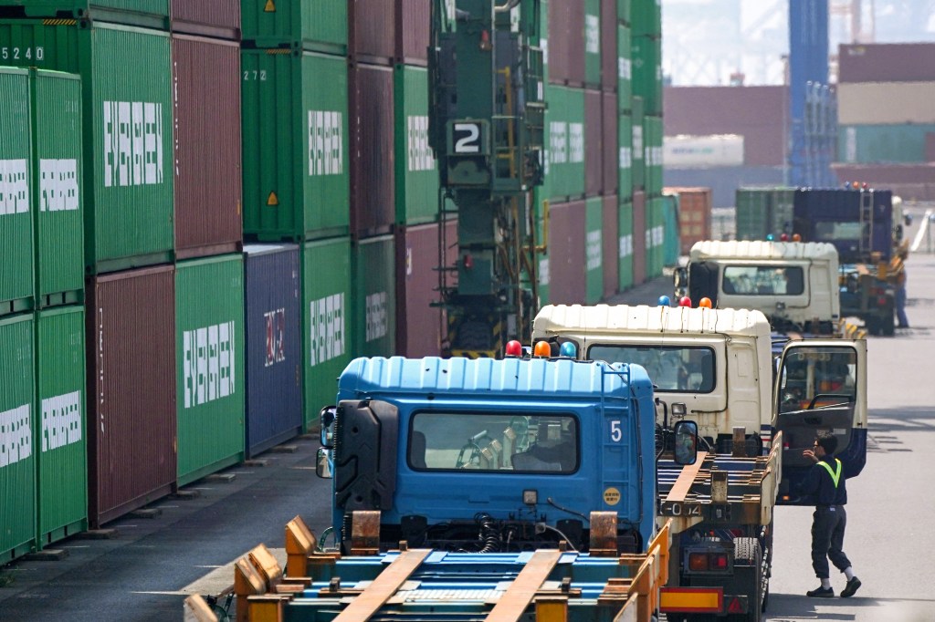 Trucks waiting to load containers at a Tokyo port.