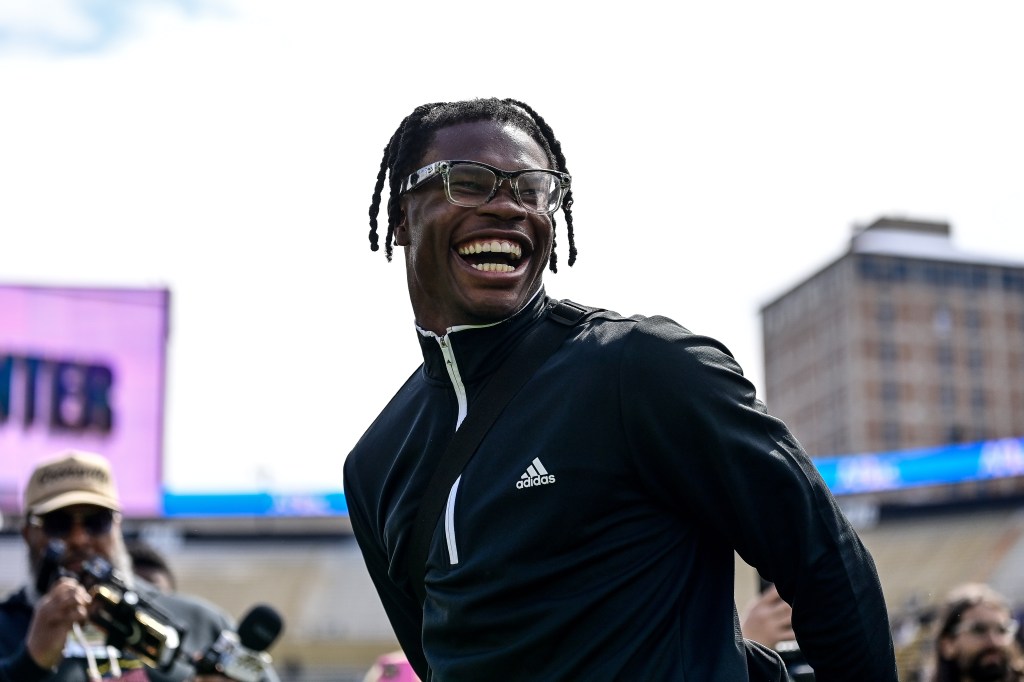 Former Colorado Buffaloes player Travis Hunter smiling at his jersey retirement ceremony during the Black and Gold Spring Game at Folsom Field, Boulder, Colorado.