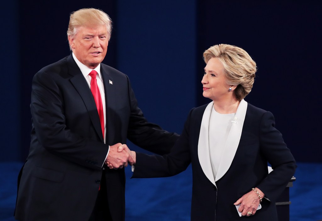 Hillary Clinton and Donald Trump shaking hands at a presidential debate.