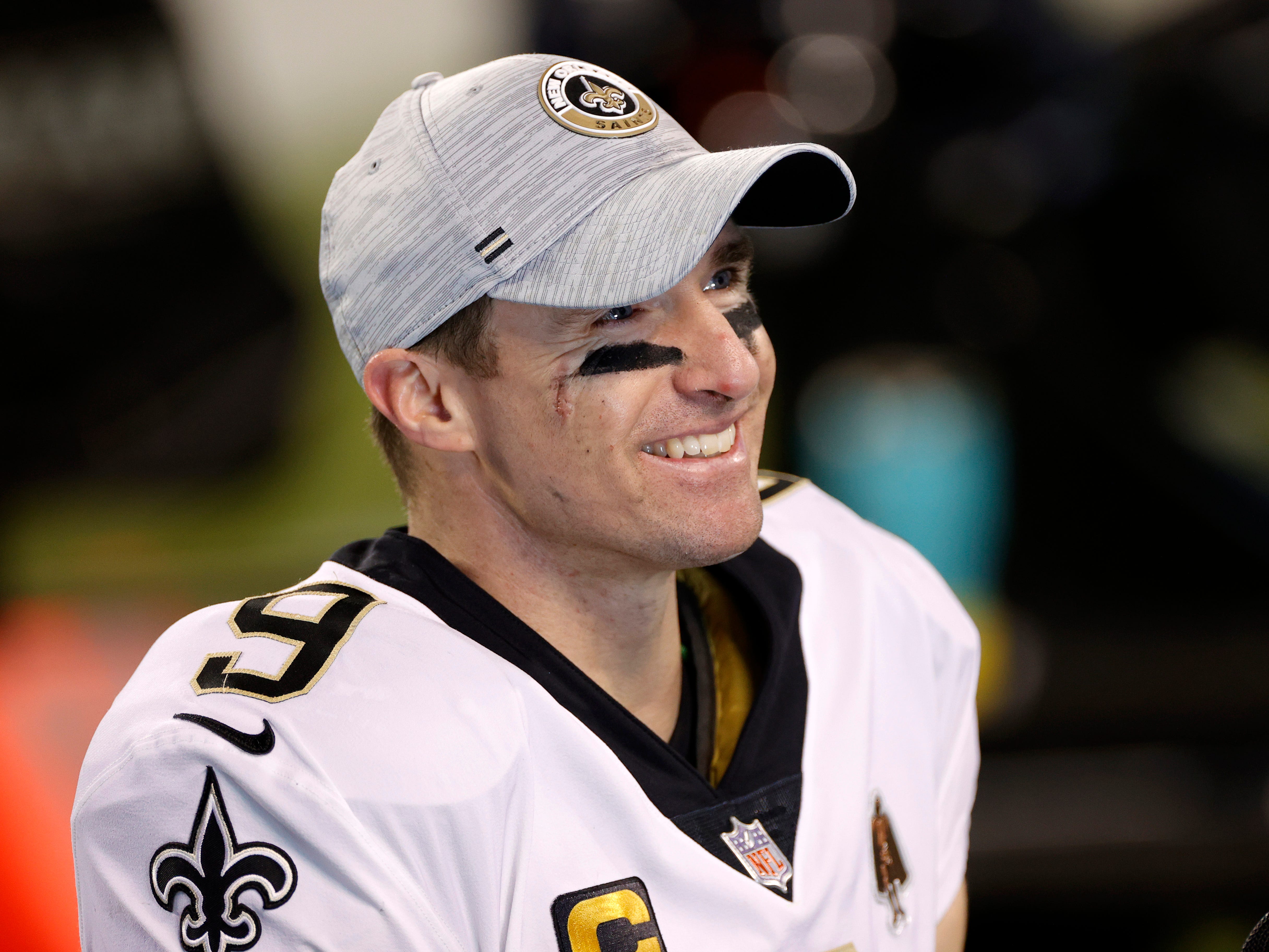 Drew Brees, #9 of the New Orleans Saints, smiling after a win over the Carolina Panthers in January 2021.