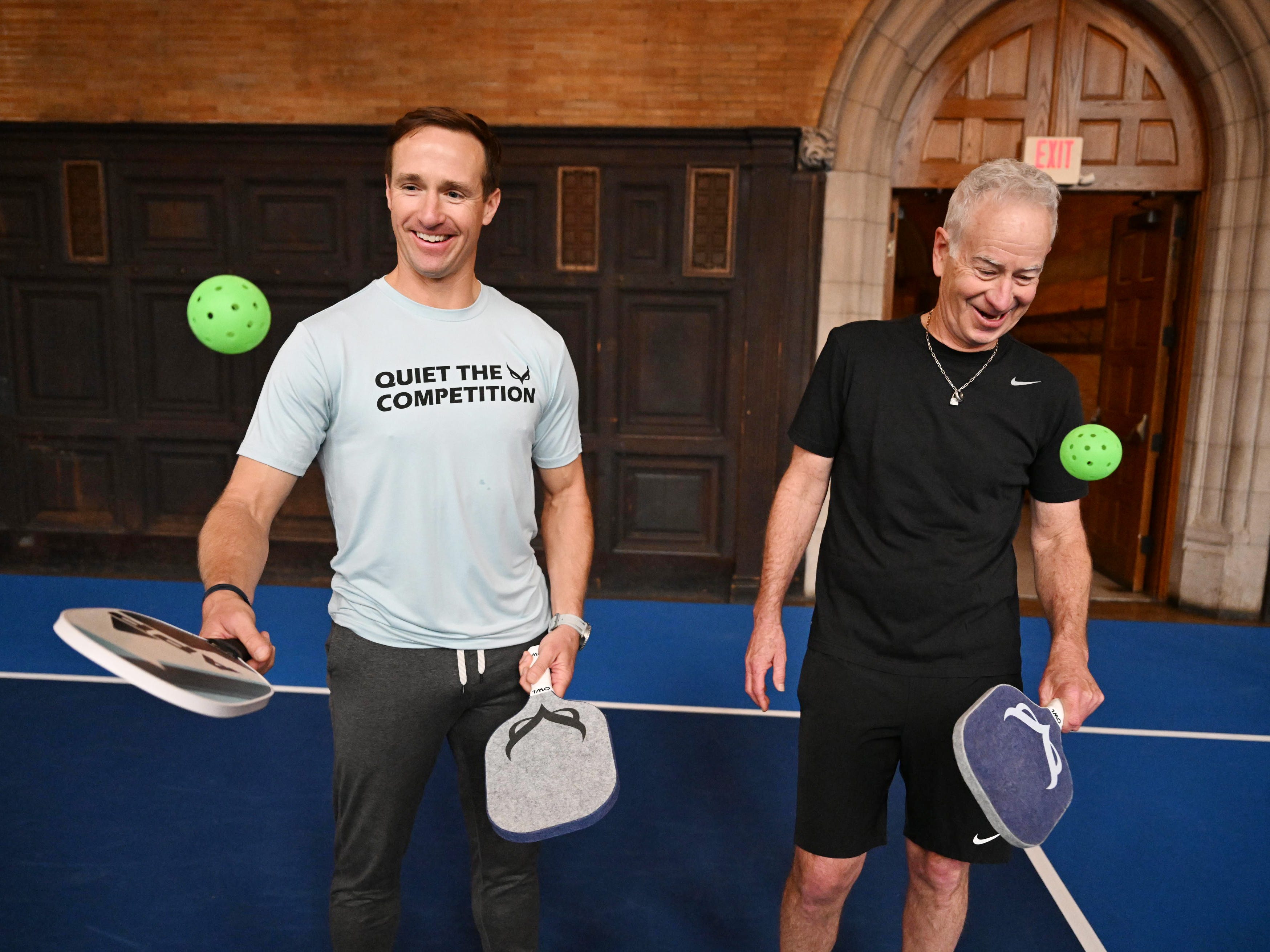 Drew Brees and John McEnroe using the OWL Pickleball Paddle in November 2023.