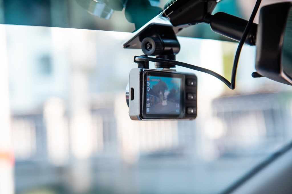 Dashcam mounted on a car windshield.