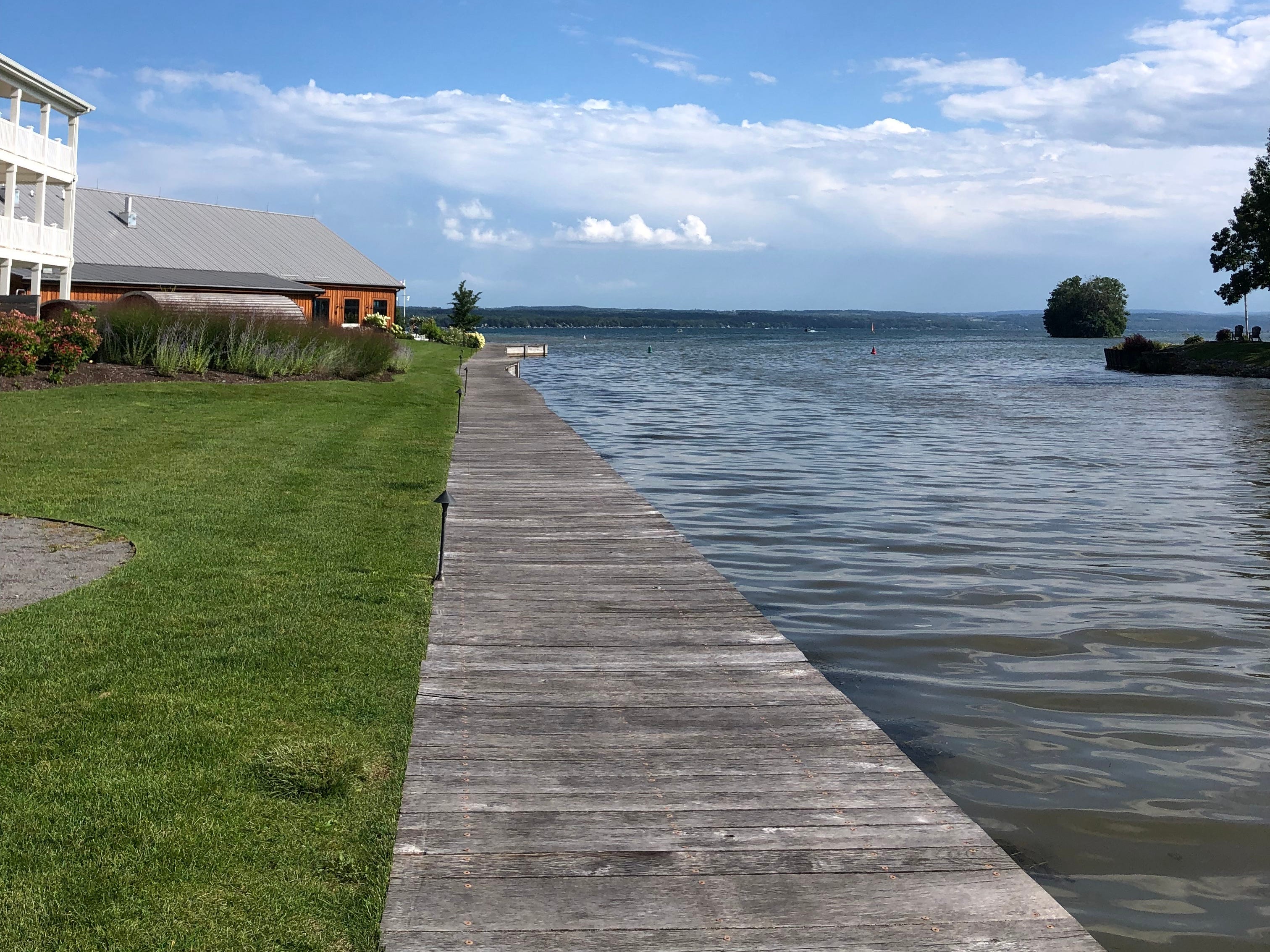 Buildings and a narrow pier near a lake.