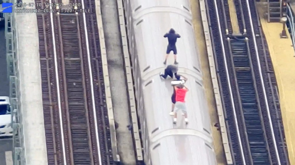 Drone footage of four youths subway surfing on a Bronx train.