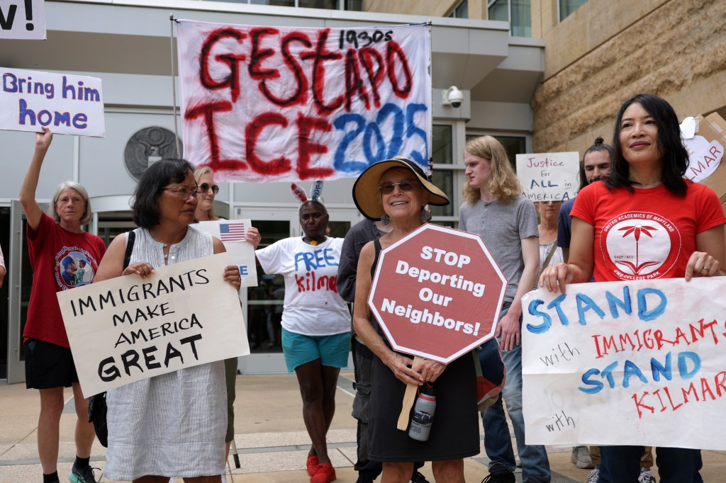 Protestors holding signs supporting Kilmar Abrego Garcia.