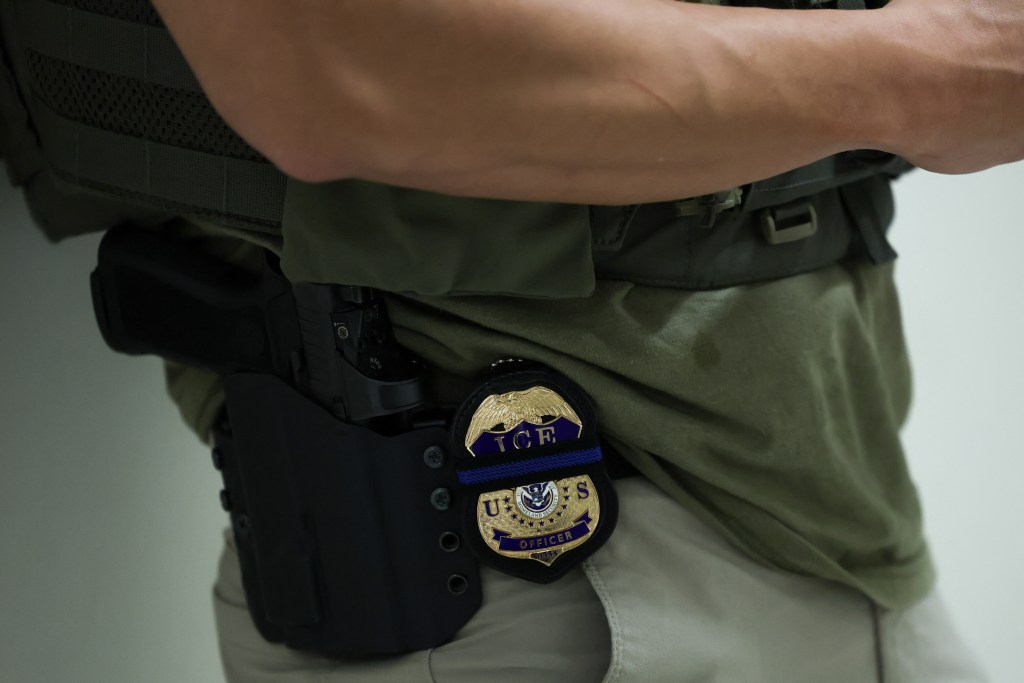 ICE officer's badge and firearm.