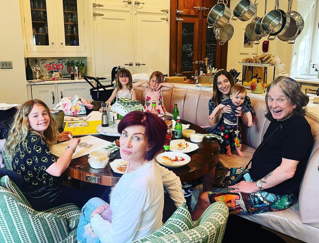 Ozzy and Sharon Osbourne at a table with family. 