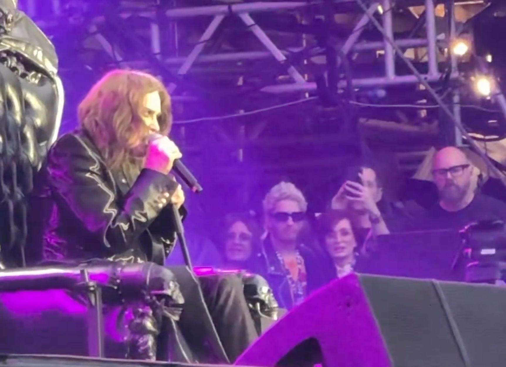 Ozzy Osbourne sings onstage. 