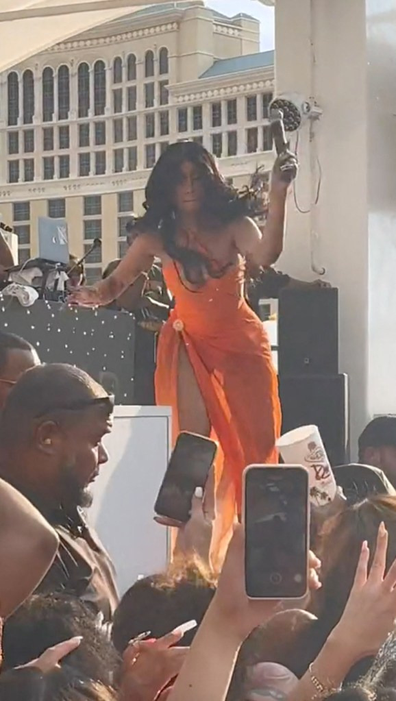 Cardi B throws a microphone at an audience member who hurled a drink at her.