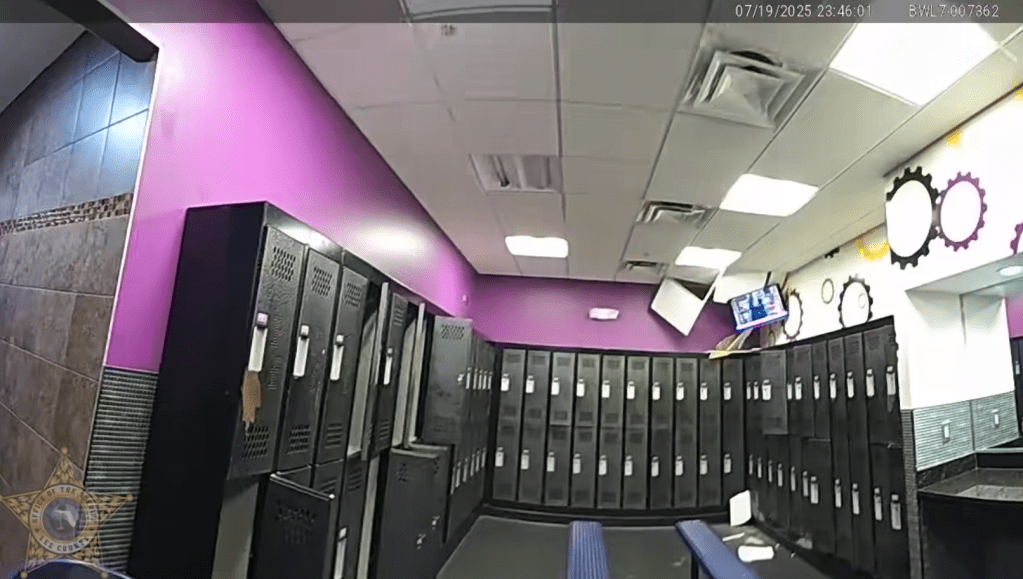 Ceiling tiles hang in the men's locker room of Planet Fitness after the naked man's rampage throughout the gym.