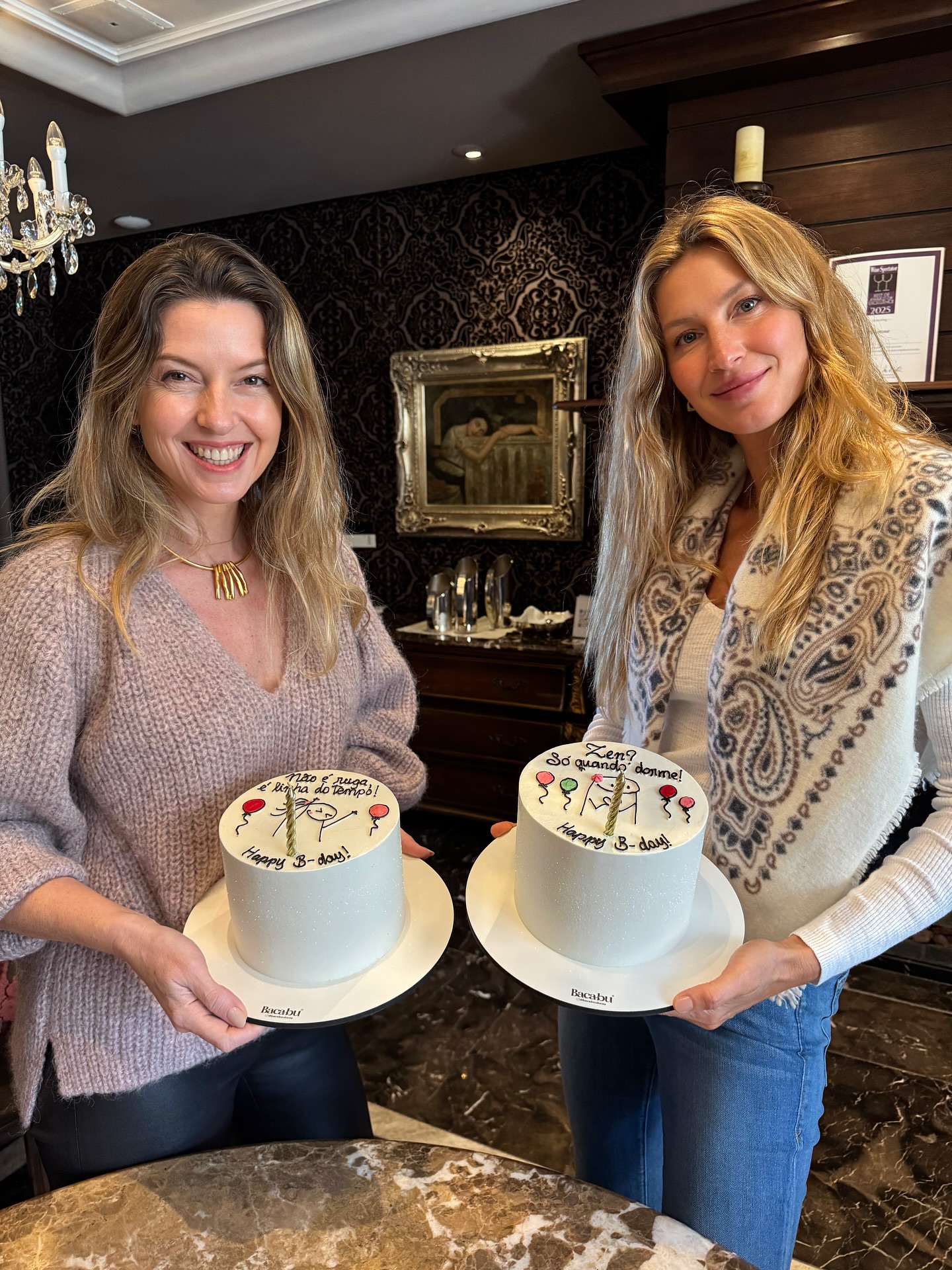 Gisele Bündchen holding her birthday cake with a friends