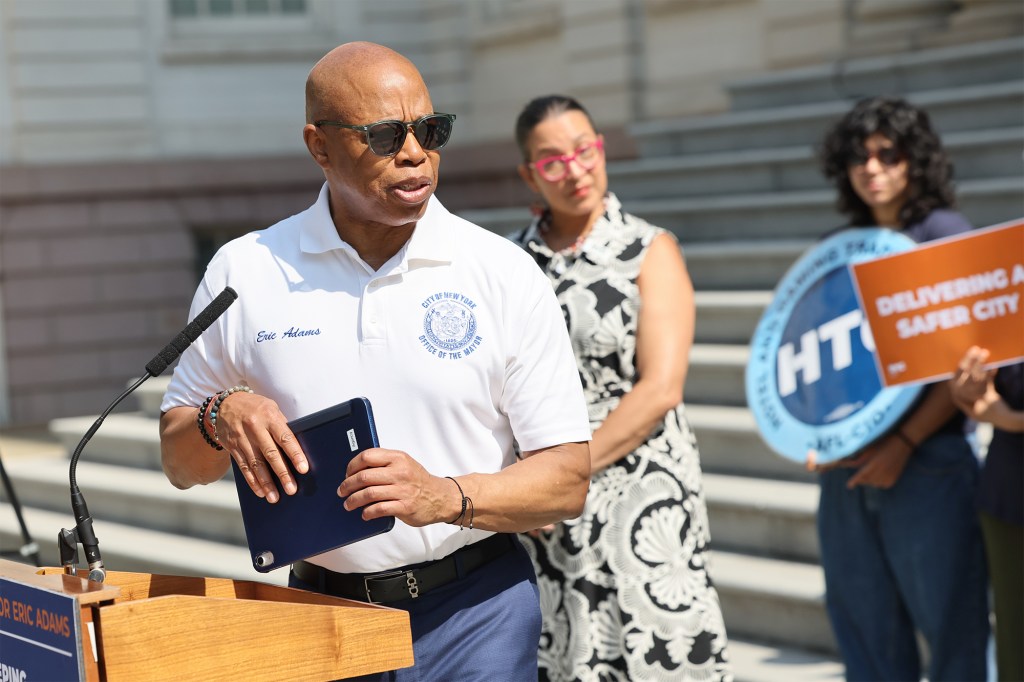 Mayor Eric Adams at a press conference at City hall steps providing information about hotel regulation with hotel union members. 