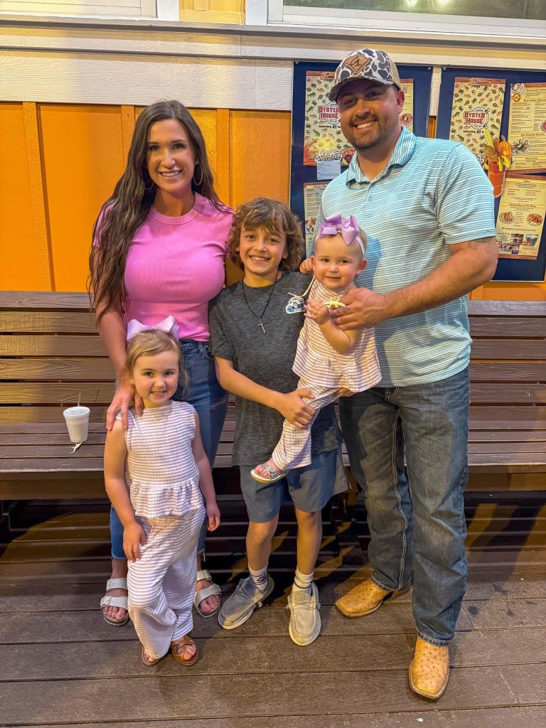 Ashely McCarley with her husband and kids outside of a restaurant. 