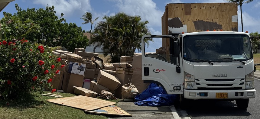 A military family's belongings are loaded into crates for a move in June 2025. 