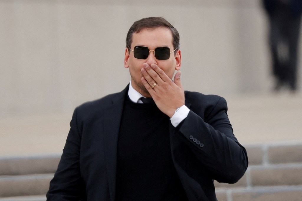 Santos blows a kiss to the cameras as he leaves a federal courthouse in Islip, NY on Oct. 27, 2023.