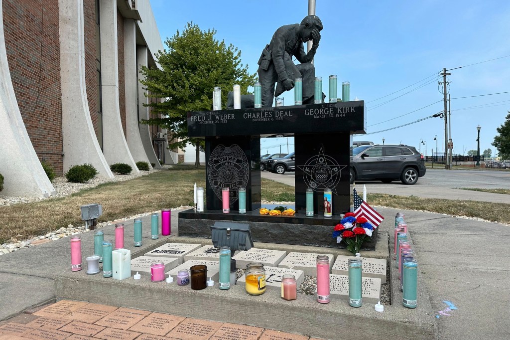 Candles sit on a memorial outside the police department in Lorain, Ohio, on Thursday, July 24, 2025
