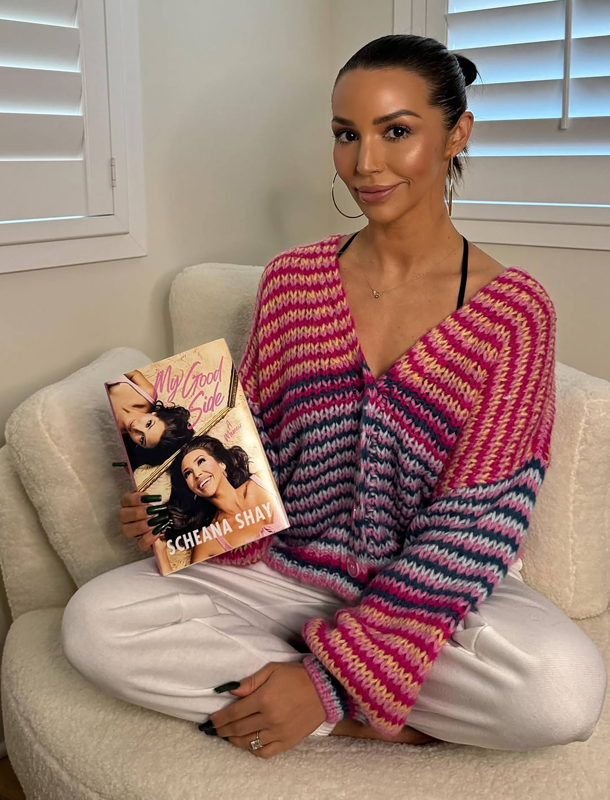 Scheana Shay holding her book.