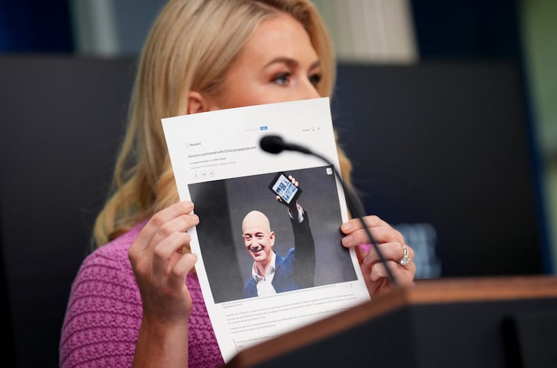 White House press secretary Karoline Leavitt holds a news article on Amazon CEO Jeff Bezos as she speaks in the Brady Press Briefing Room at the White House on April 29, 2025 in Washington, D.C.