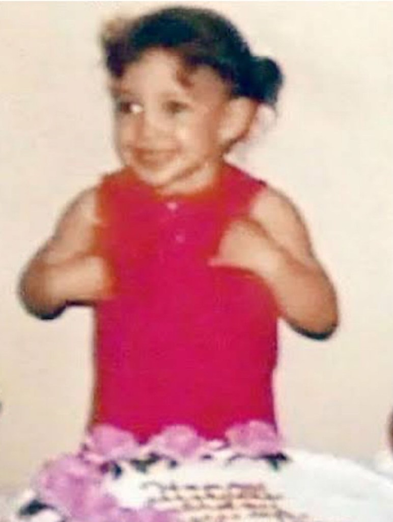 Jennifer Lopez young in front of a cake