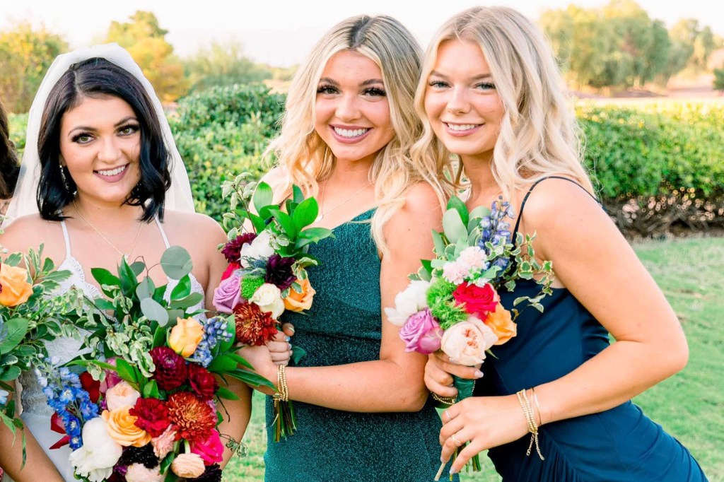 Photo of Kaylee Goncalves' sister with two friends at a wedding.