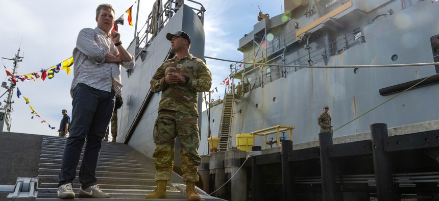Army Secretary Dan Driscoll talks to Chief Warrant Officer 2 Adam Davis, the 1st mate of USAV SSG Elroy F. Wells (MSV-L) about the capabilities of the Maneuver Support Vessel (Light) on July 21, 2025, at Joint Base Pearl Harbor-Hickam, Hawaii.