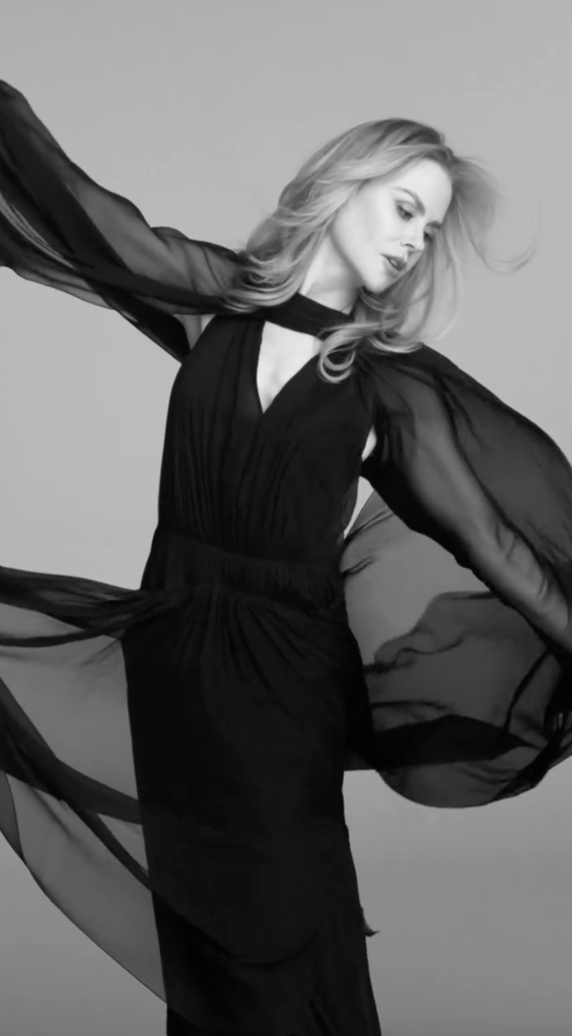 Nicole Kidman in a dress with a sheer cape. 