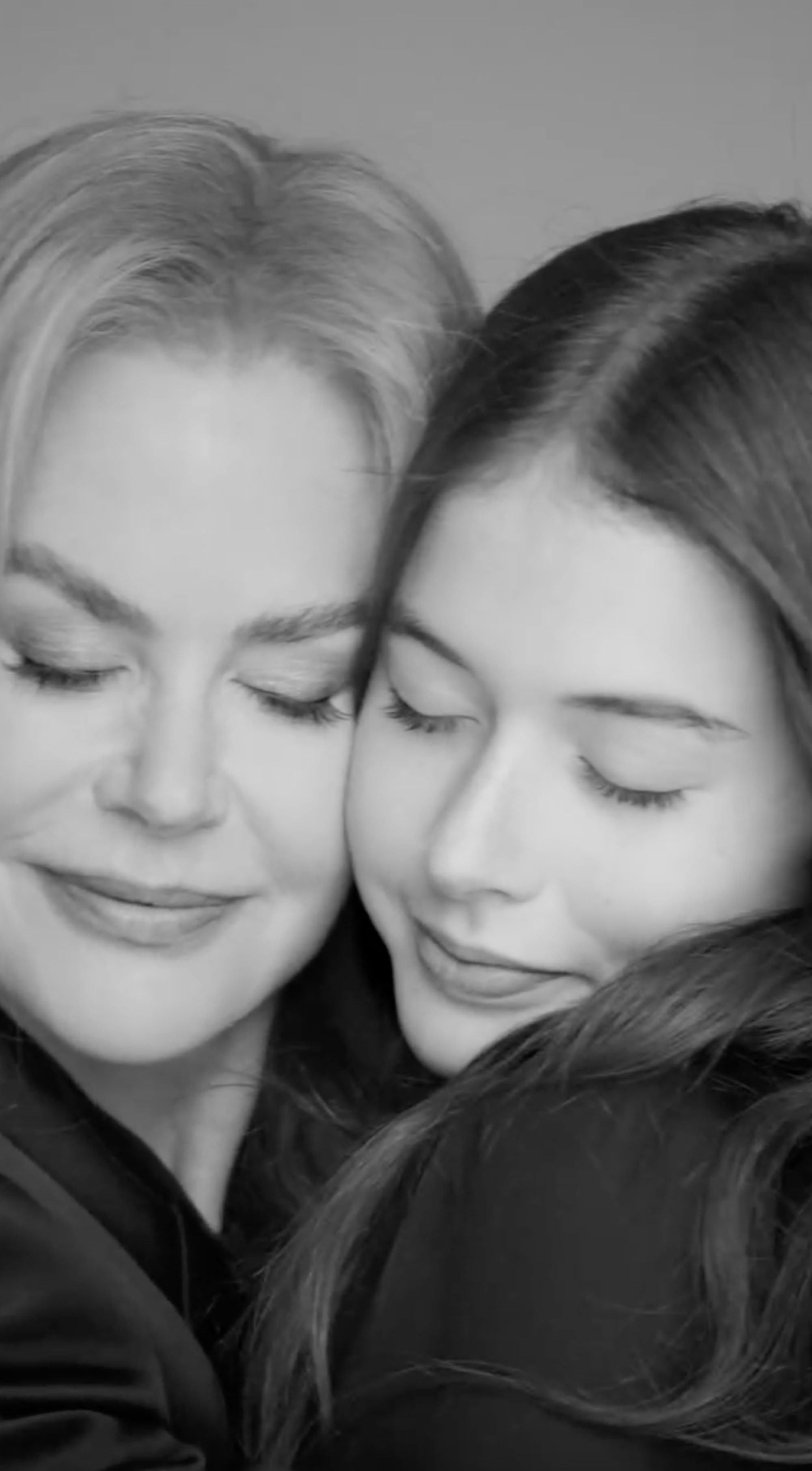 Nicole Kidman and Faith Urban hug in a black and white video. 