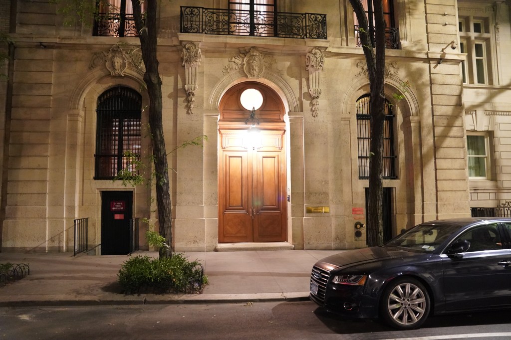 Damaged front door of Jeffrey Epstein's home after an FBI raid.