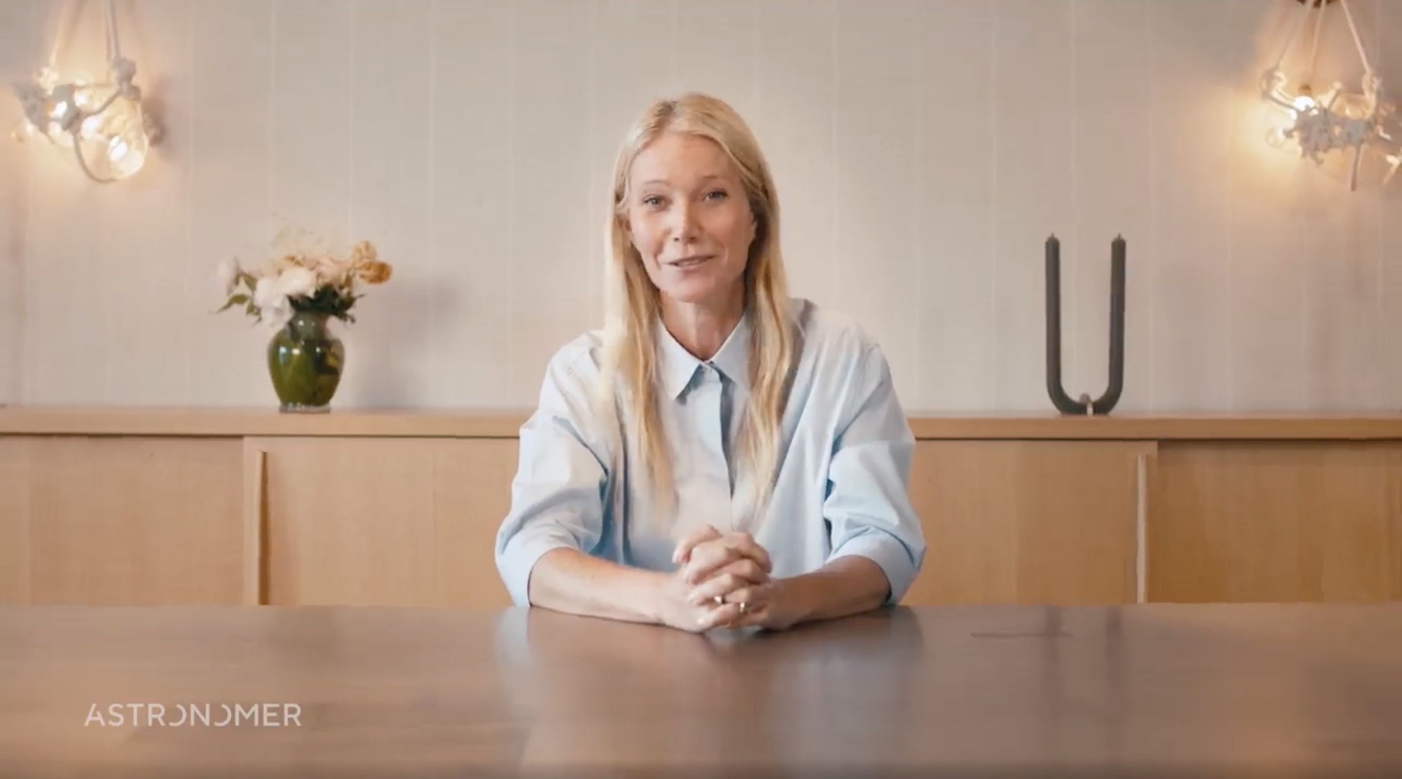 Gwyneth Paltrow sits at a desk. 
