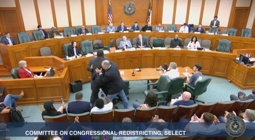 A Texas congressional candidate being removed from a redistricting hearing.