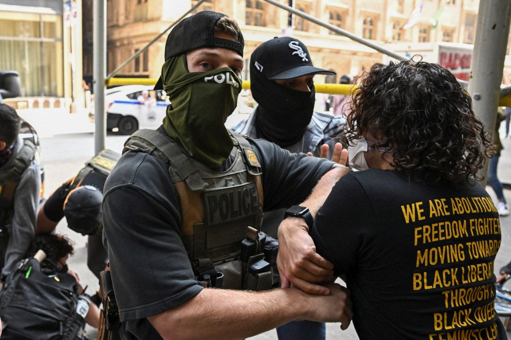 Federal agents hold back a protester during an ICE exercise outside an immigration court in Chicago on June 16, 2025.  